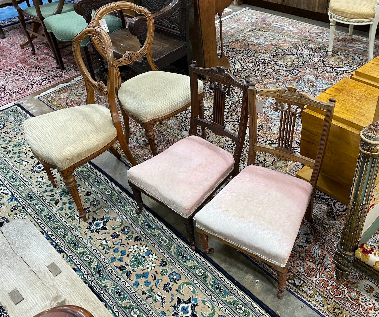 A pair of Victorian carved walnut balloon back dining chairs and a pair of late Victorian nursing chairs